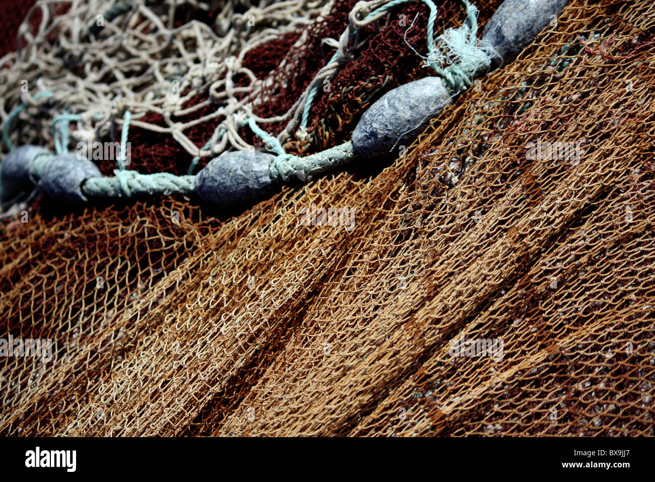 Close view of some fishing net and led weights on the docks Stock Photo -  Alamy