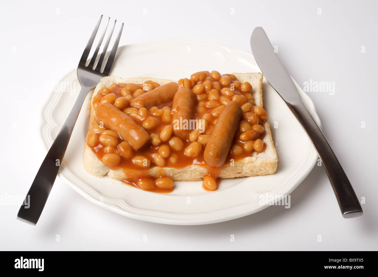 Heinz baked beans and pork sausages on toast Stock Photo
