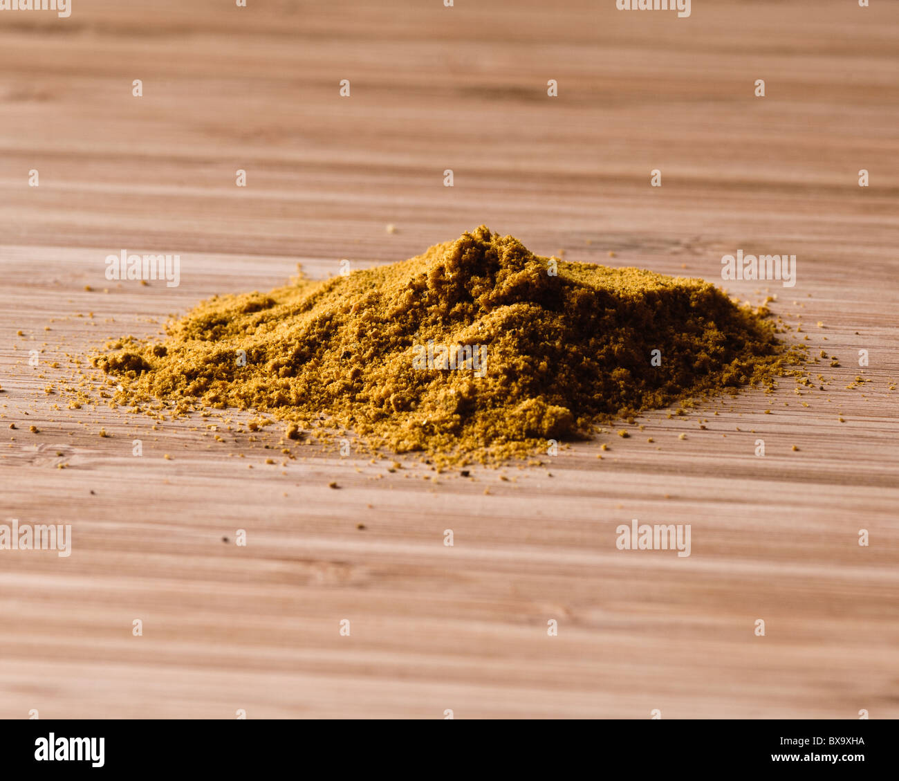 powder curry on a unsharpened chopping board Stock Photo