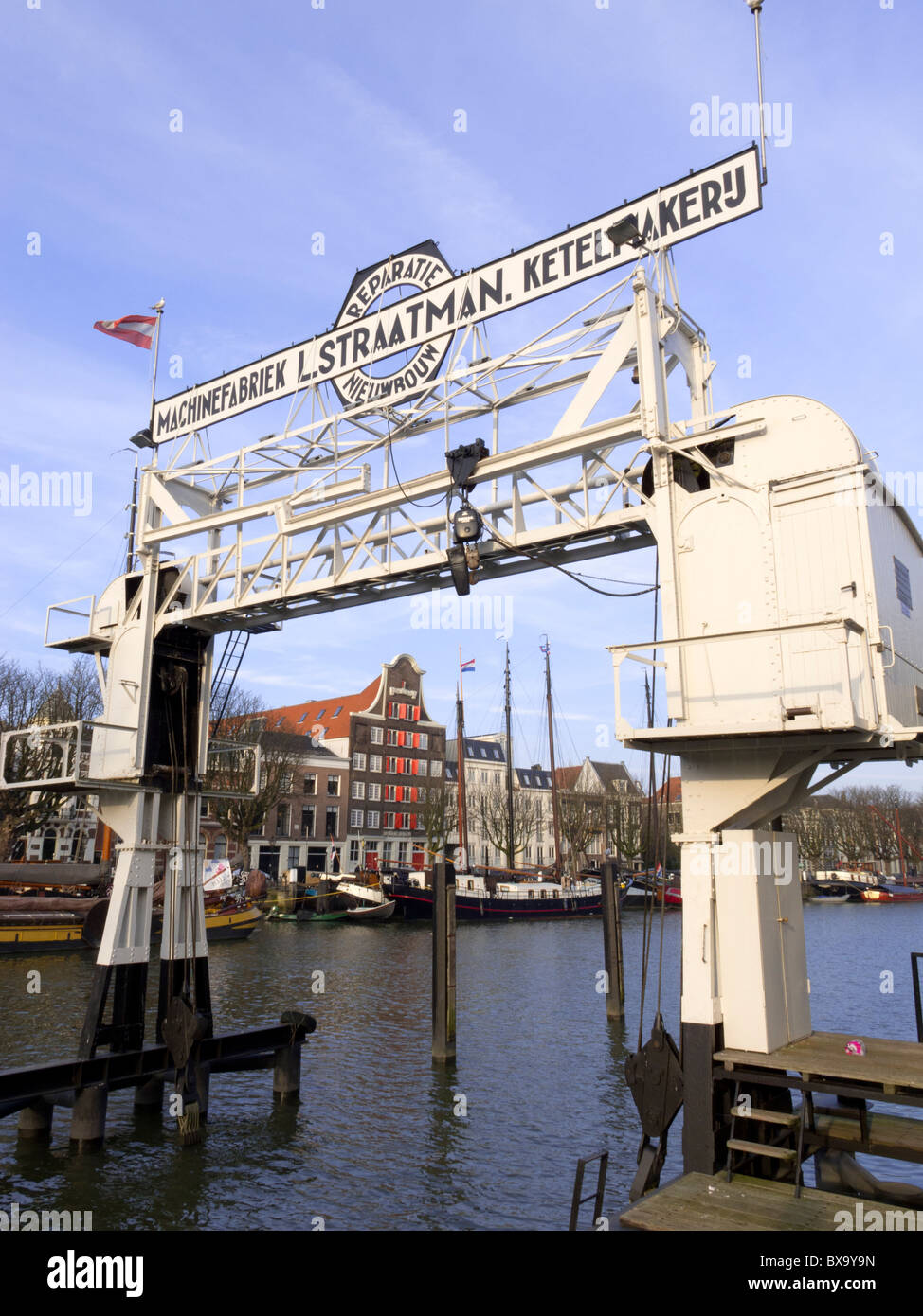 Historic crane in harbour at Dordrecht in The Netherlands Stock Photo