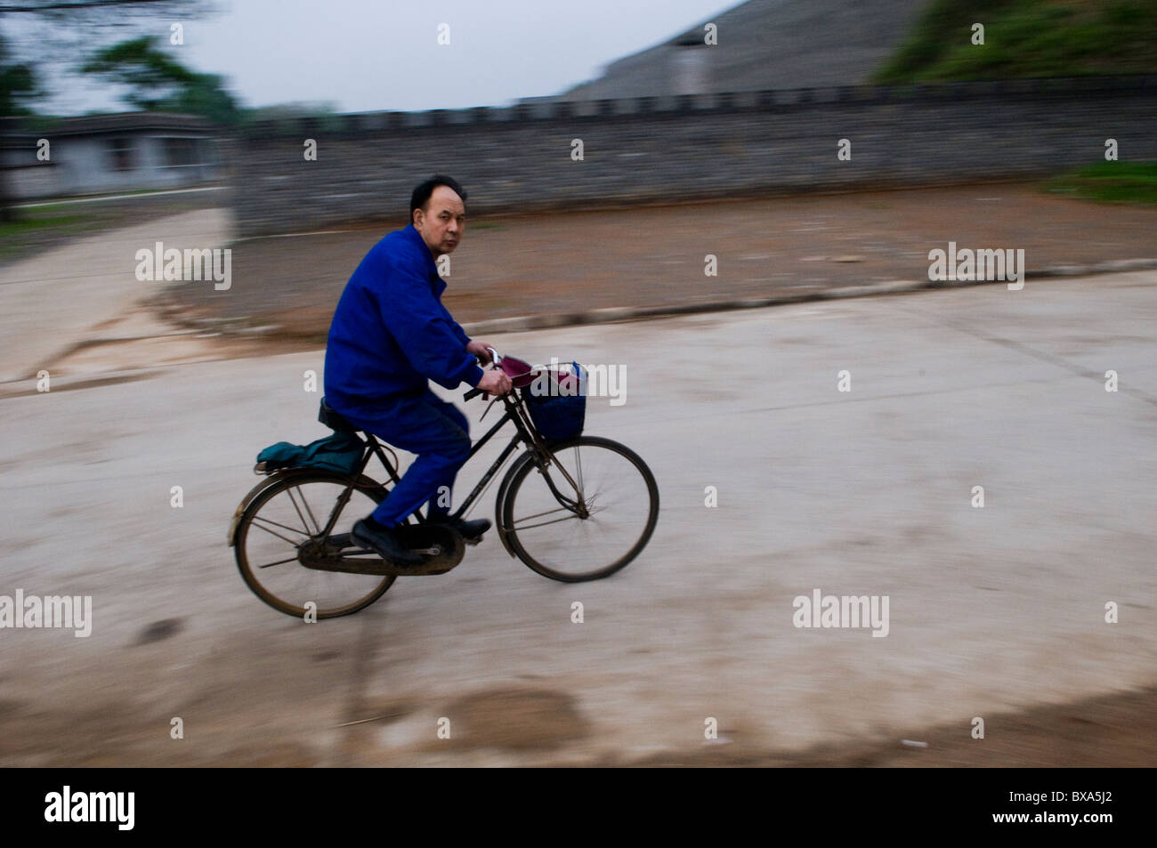 Rushing home, A Chinese man on his cycle. Stock Photo