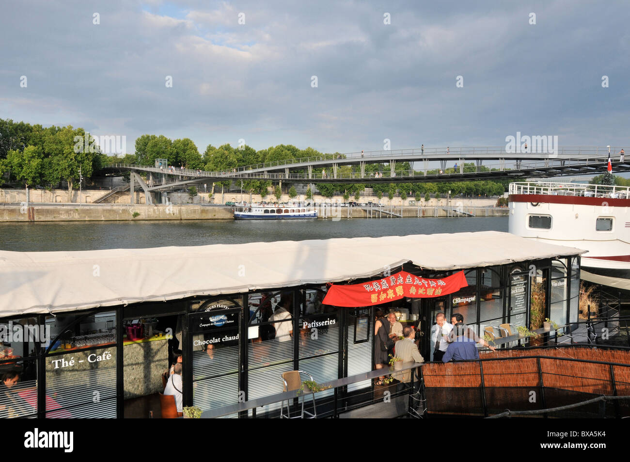café on barge, Seine river, Simone de Beauvoir bridge, Paris, France Stock Photo