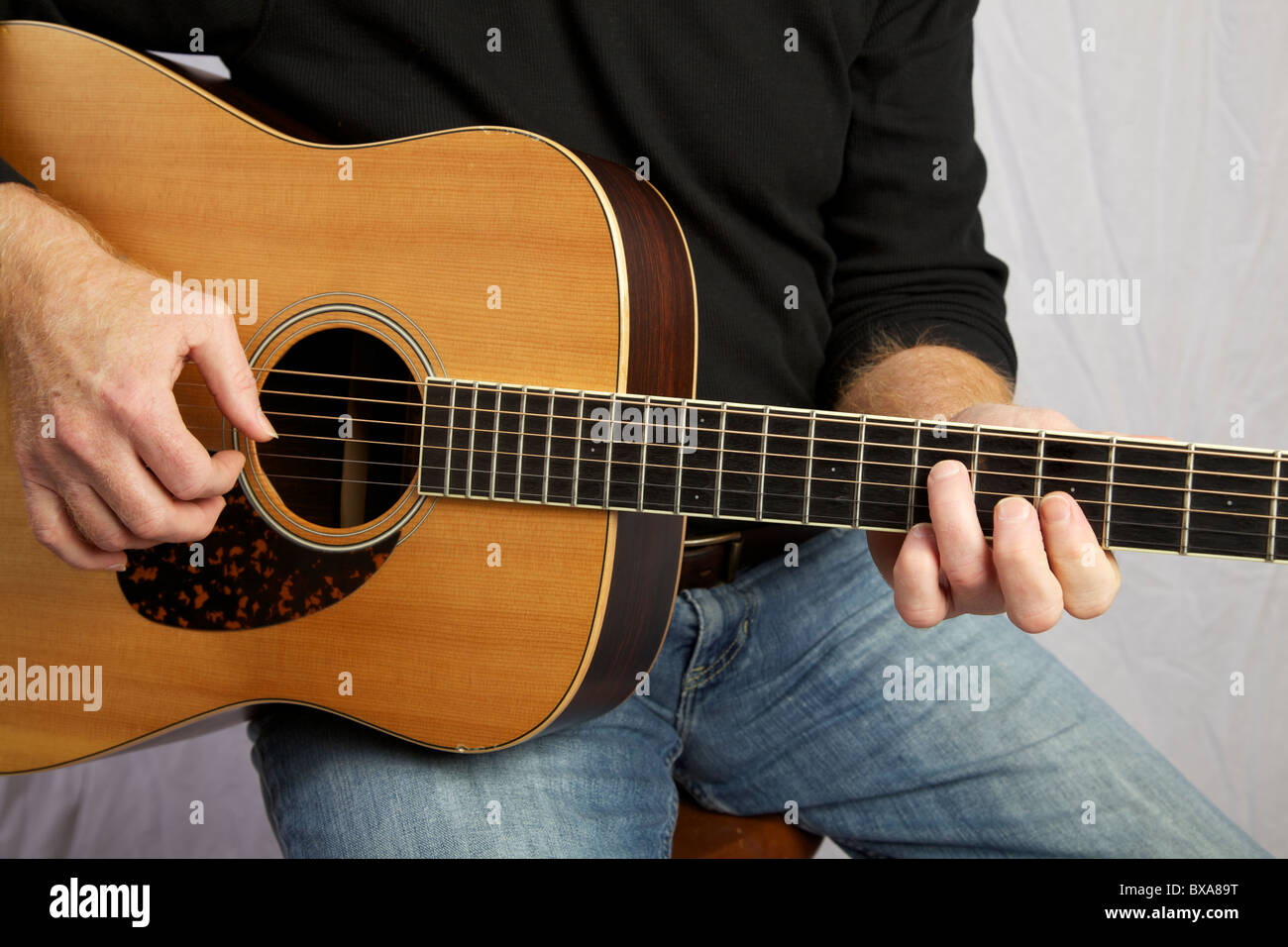 Man playing guitar. Face not shown. Stock Photo