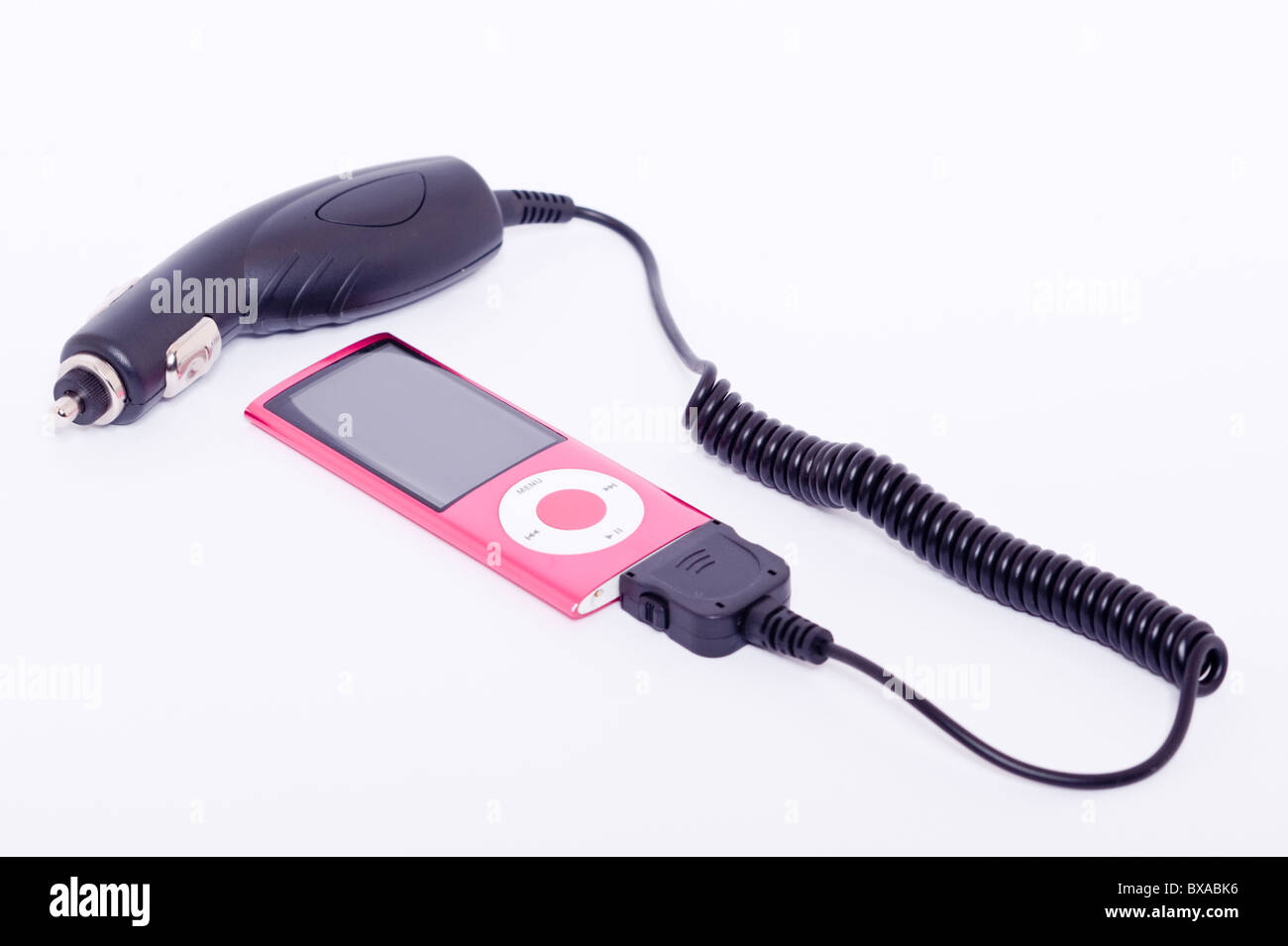 An Ipod Nano 5th generation digital music player with car charger attatched on a white background Stock Photo