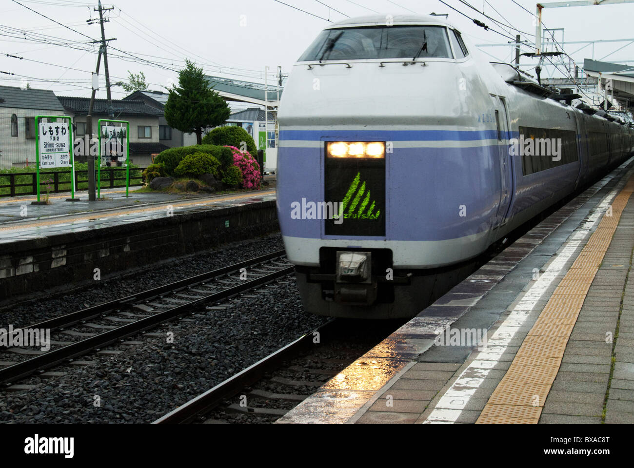The Azusa Limited Express train pulls into Shimosuwa Station on central Japan's Chuo Line. Stock Photo