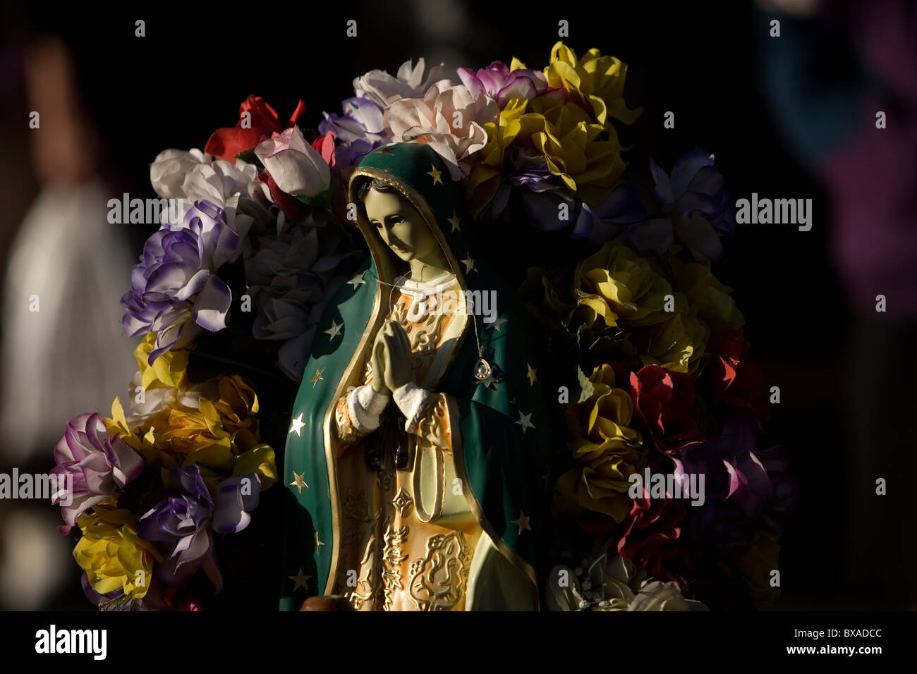 A statue of Our Lady of Guadalupe decorated with flowers, Mexico City