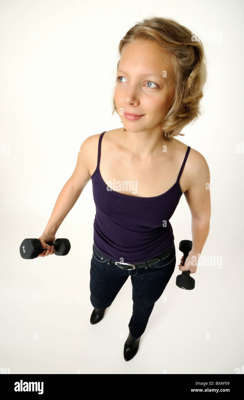 Young woman with dumbbells Stock Photo