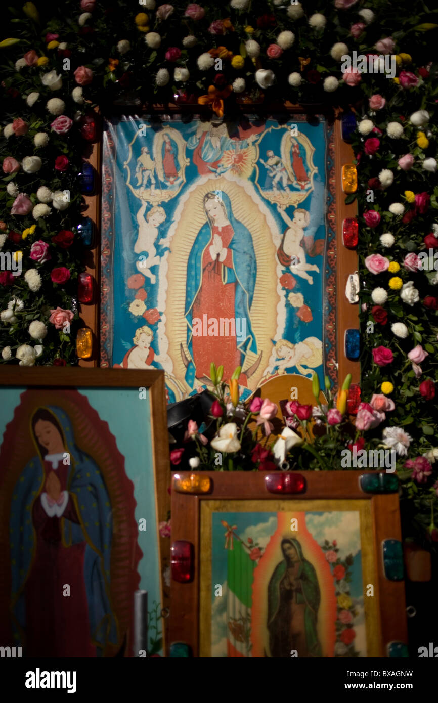Roses decorate images of the Our Lady of Guadalupe in Mexico City Stock Photo