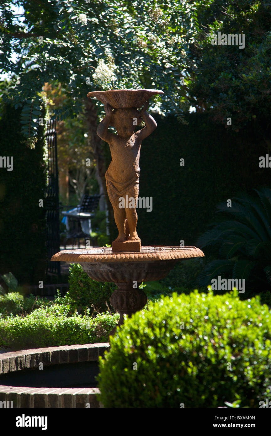Traditional cherub fountain in the garden of a historic home in