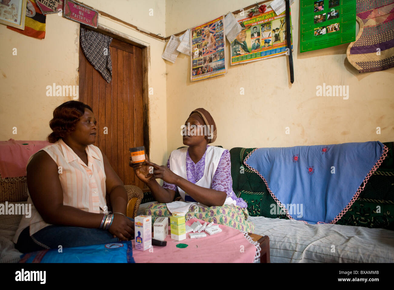 A Community Health Volunteer visits a home in Budumbuli, Jinja District, Eastern Uganda, East Africa. Stock Photo