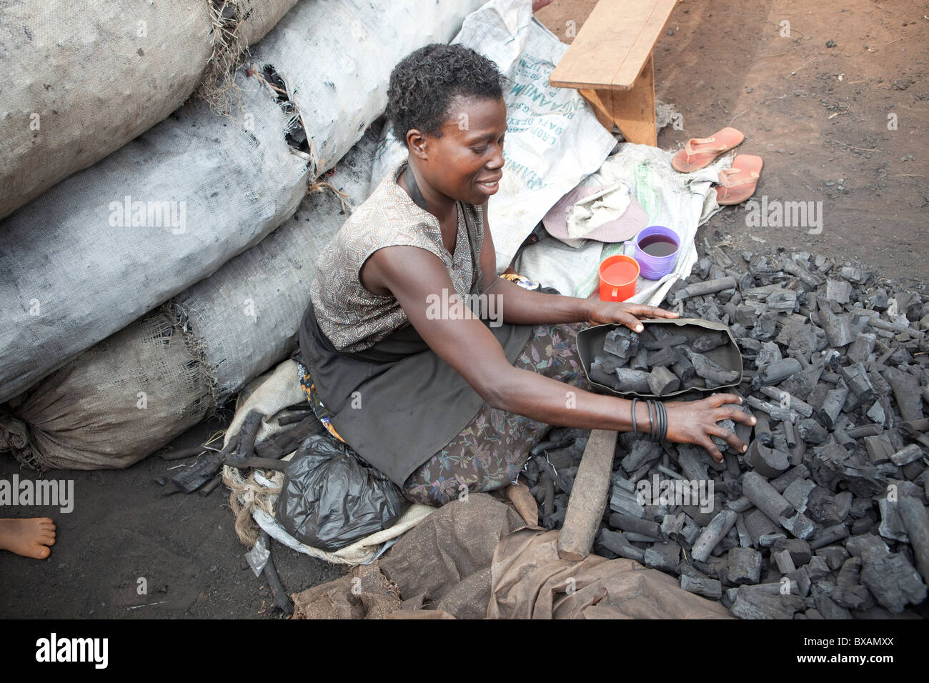A woman sells charcoal on the streets in Jinja, Uganda, East Africa