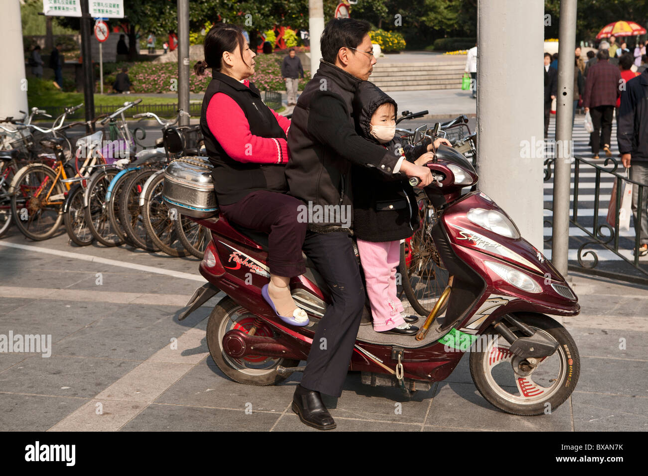 Family riding on scooter in Xijiahui District , Shanghai, China Stock Photo
