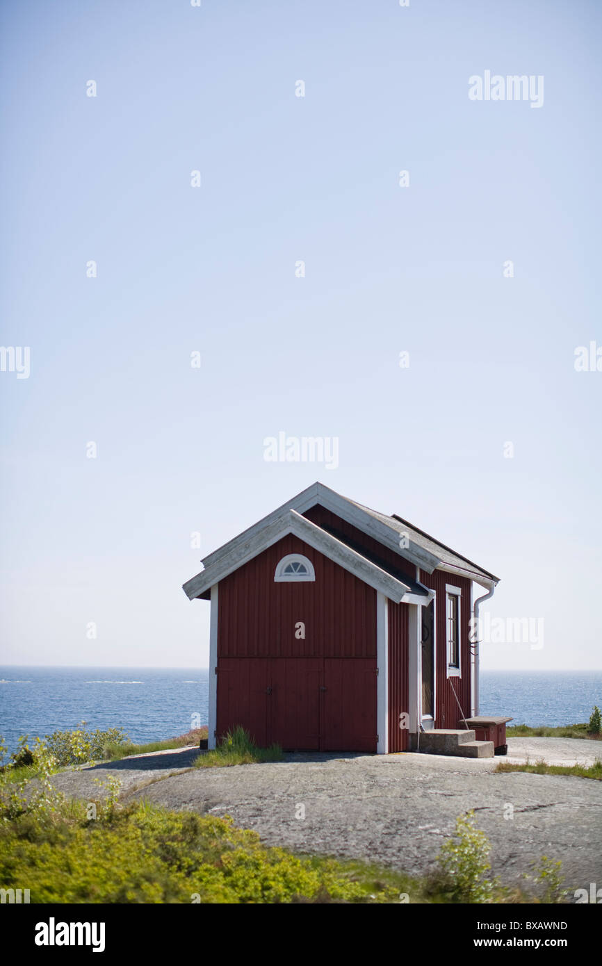 Cottages on rock next to sea Stock Photo - Alamy