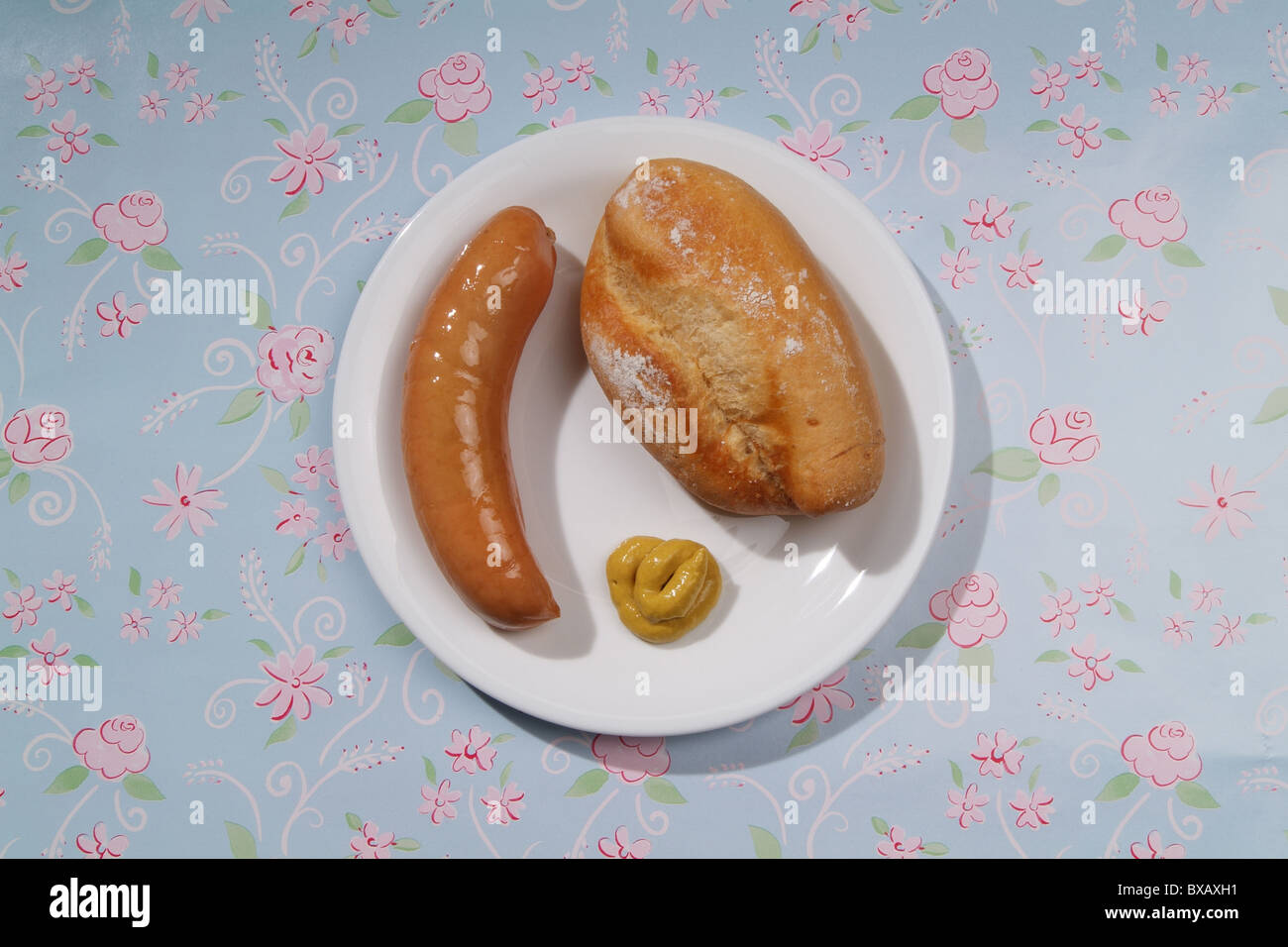 A sausage with mustard and a bun Stock Photo