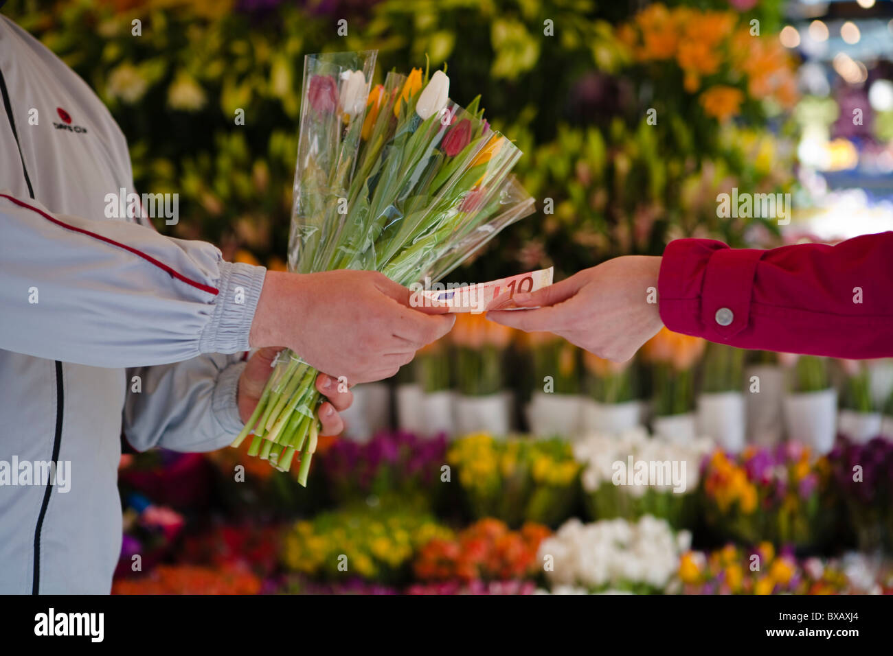 Woman paying for bunch of flowers Stock Photo