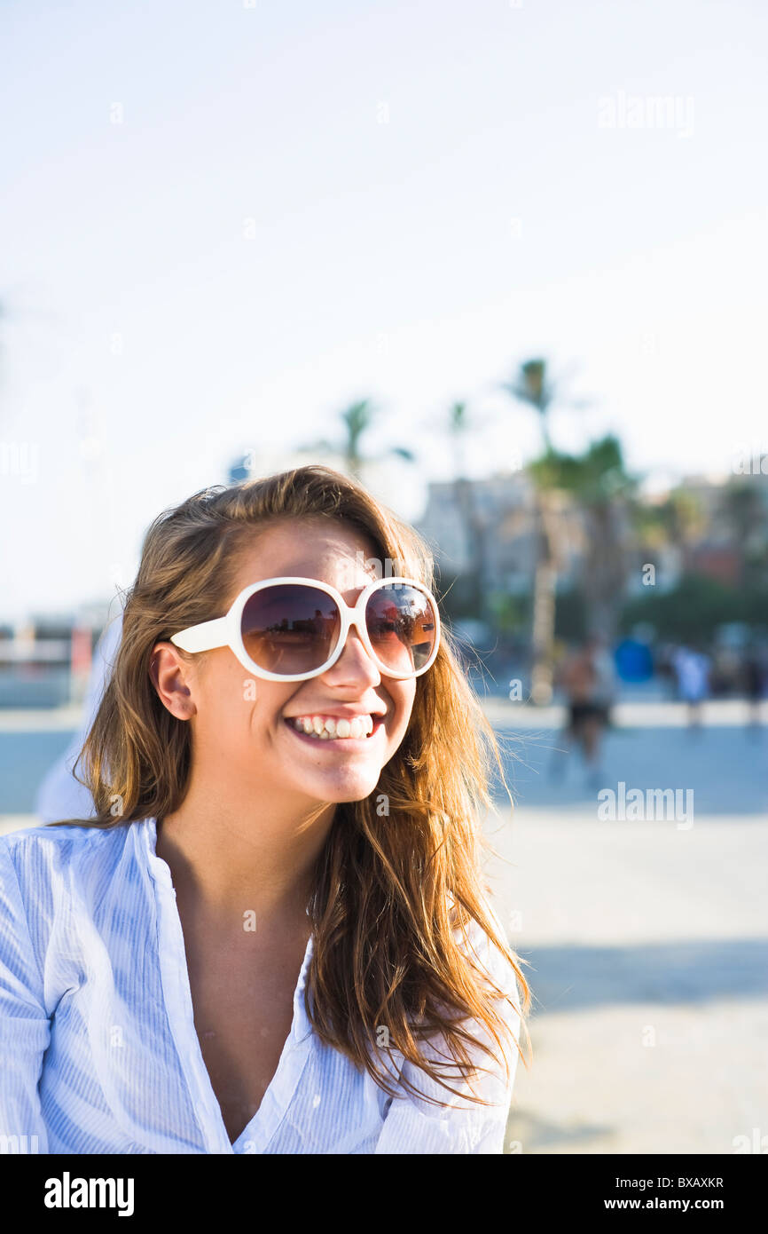 Portrait of young woman wearing sunglasses Stock Photo - Alamy