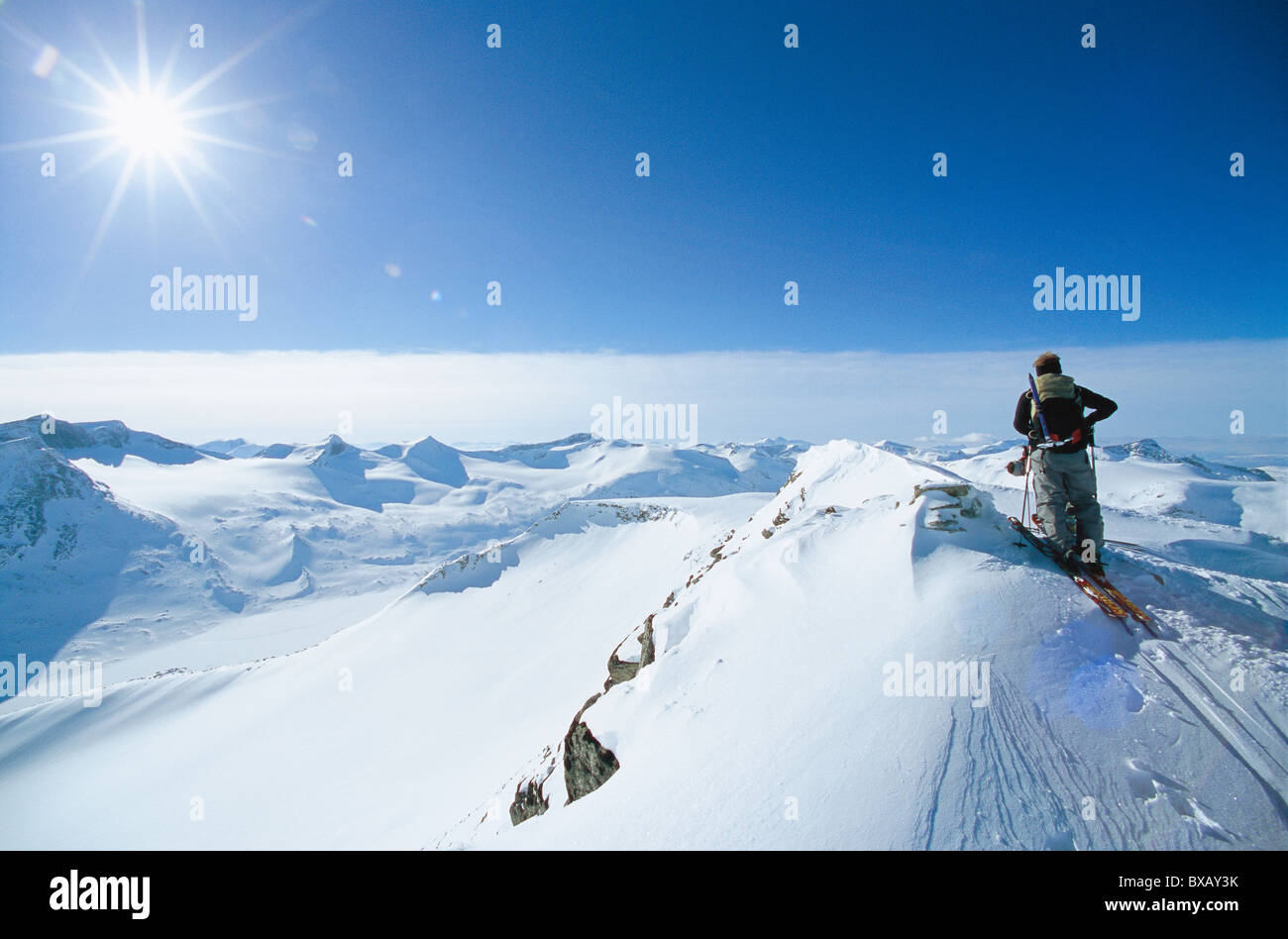 Rear view of man skiing on top of mountain Stock Photo