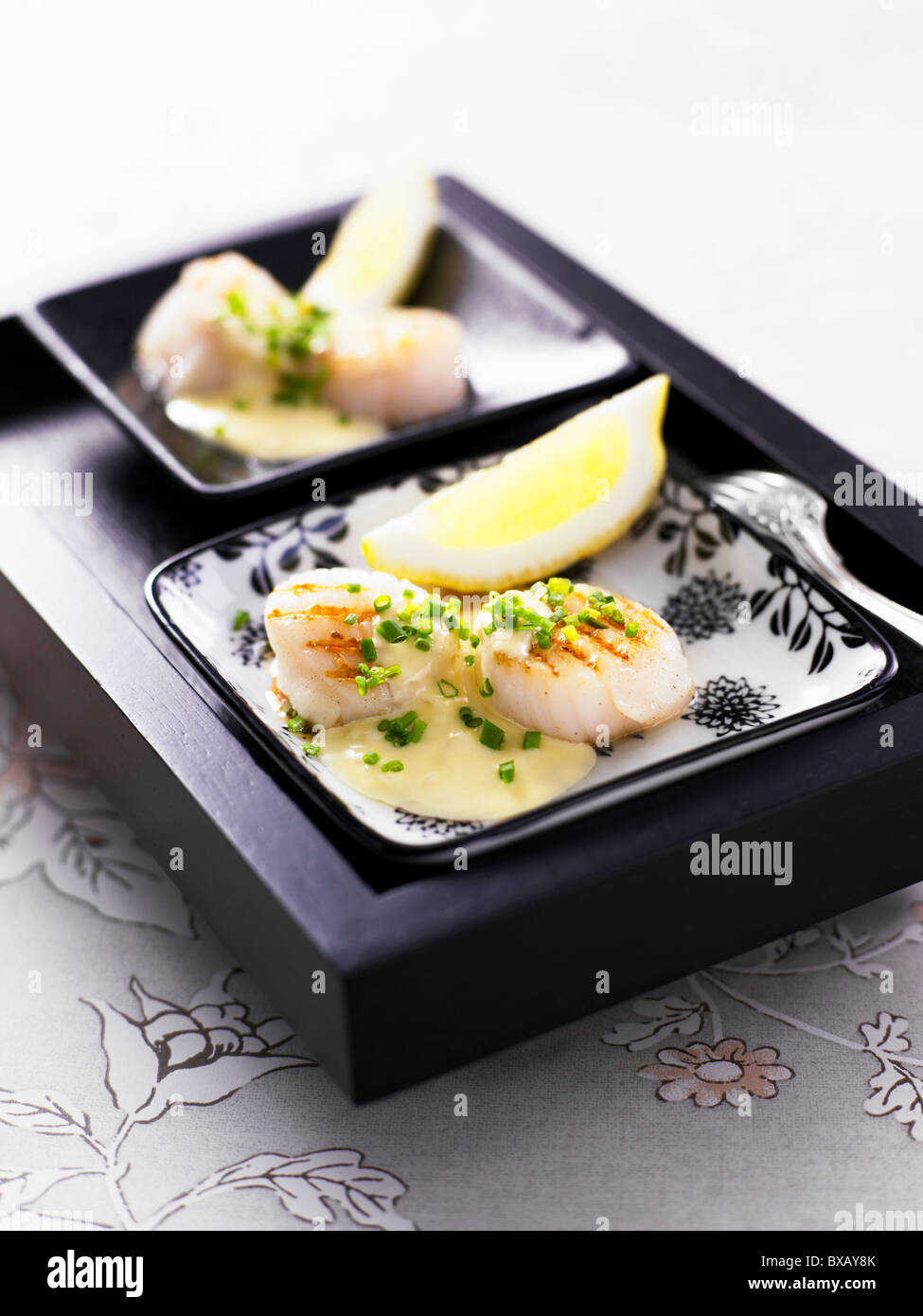 Close-up of scallop with lime slice Stock Photo