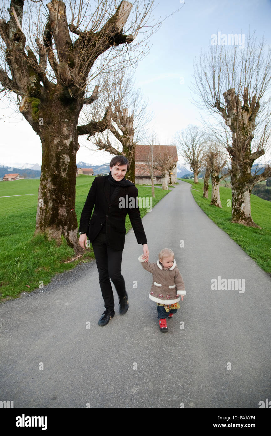 Father and daughter walking hand in hand Stock Photo - Alamy