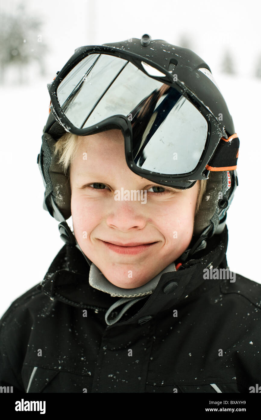 Portrait of boy wearing ski goggles and safety helmet Stock Photo