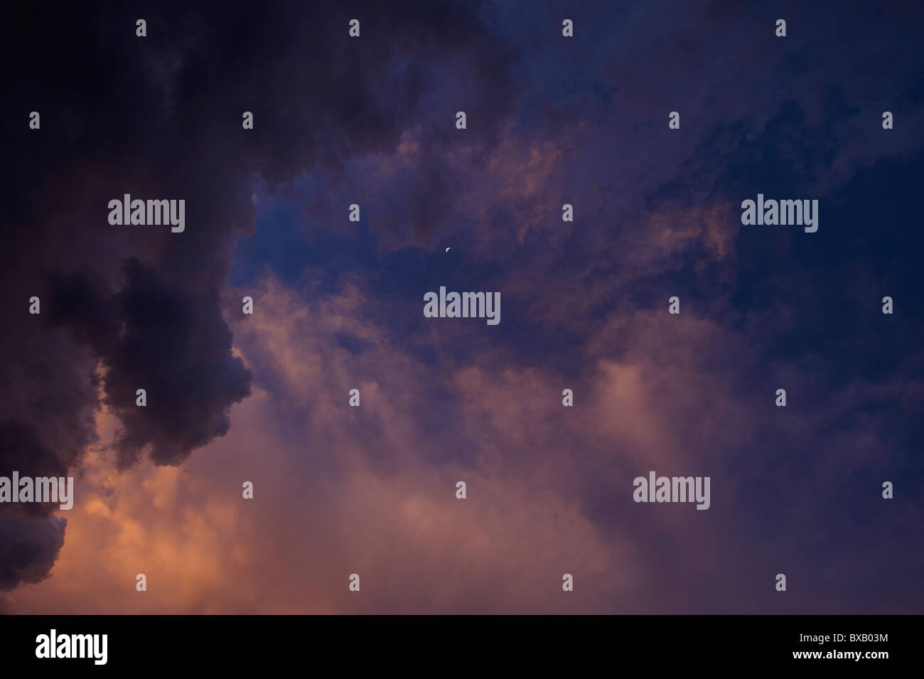 Stormy evening sky with crescent moon Stock Photo - Alamy