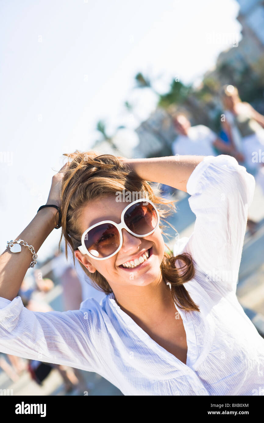 Portrait of young woman wearing sunglasses Stock Photo - Alamy