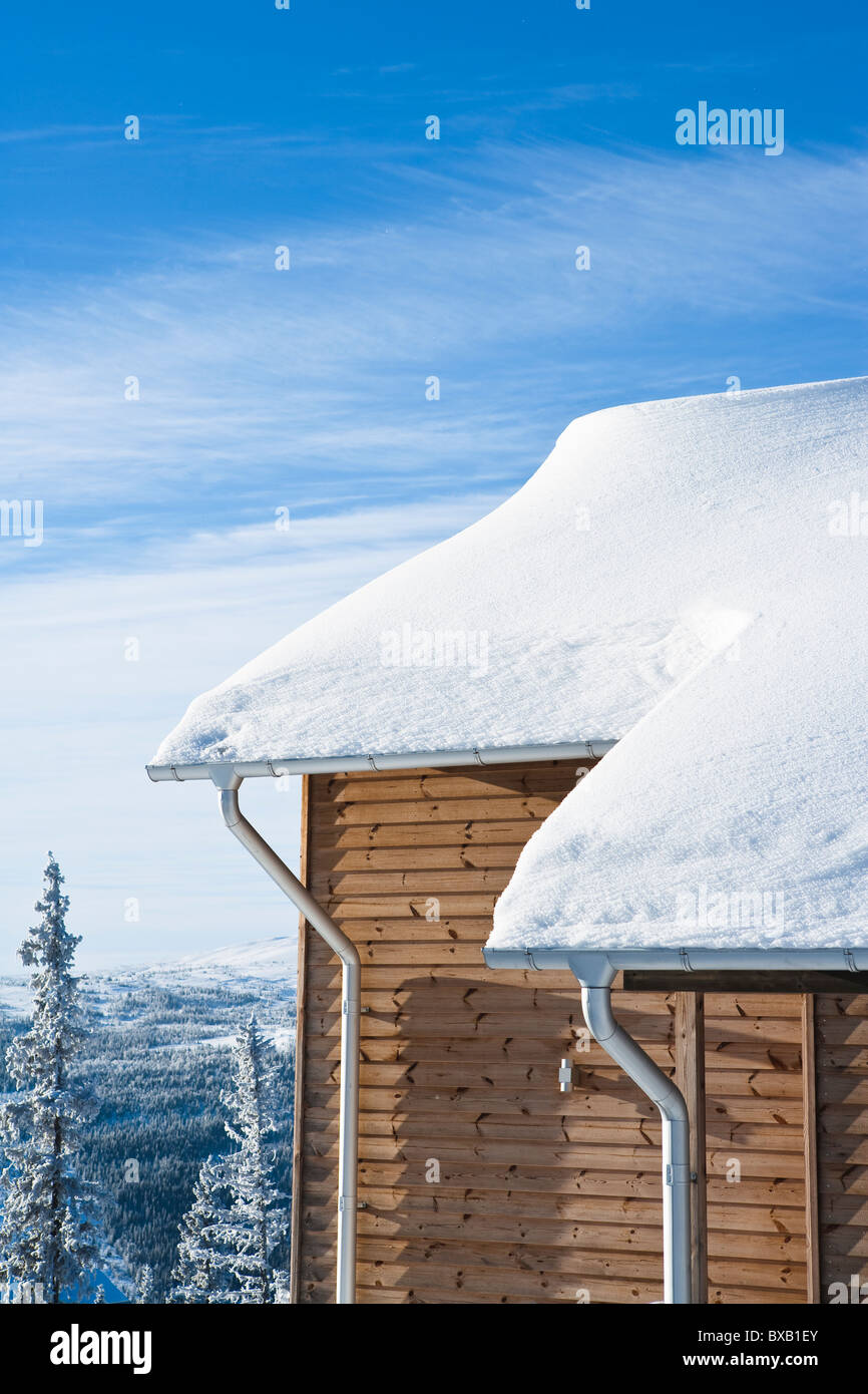Wooden house covered by snow Stock Photo - Alamy