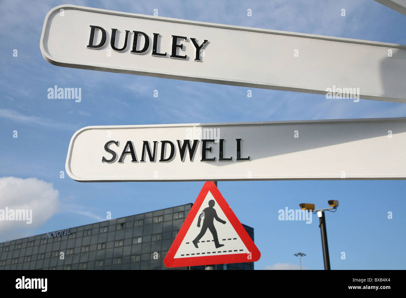 direction signs in birmingham with clouded sky in background Stock