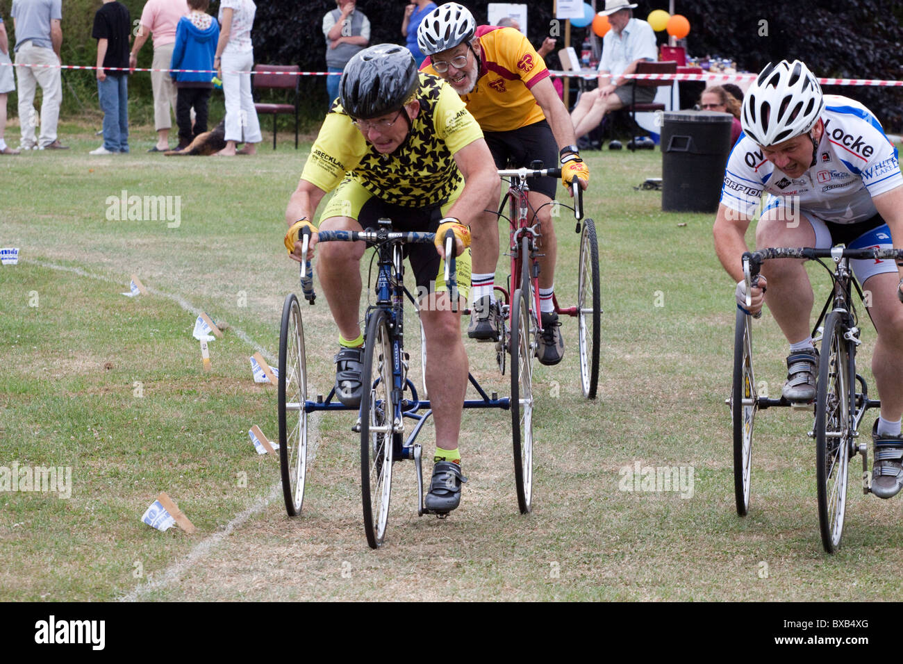 Tricycle grass track racing in a pleasantly rural location Stock Photo
