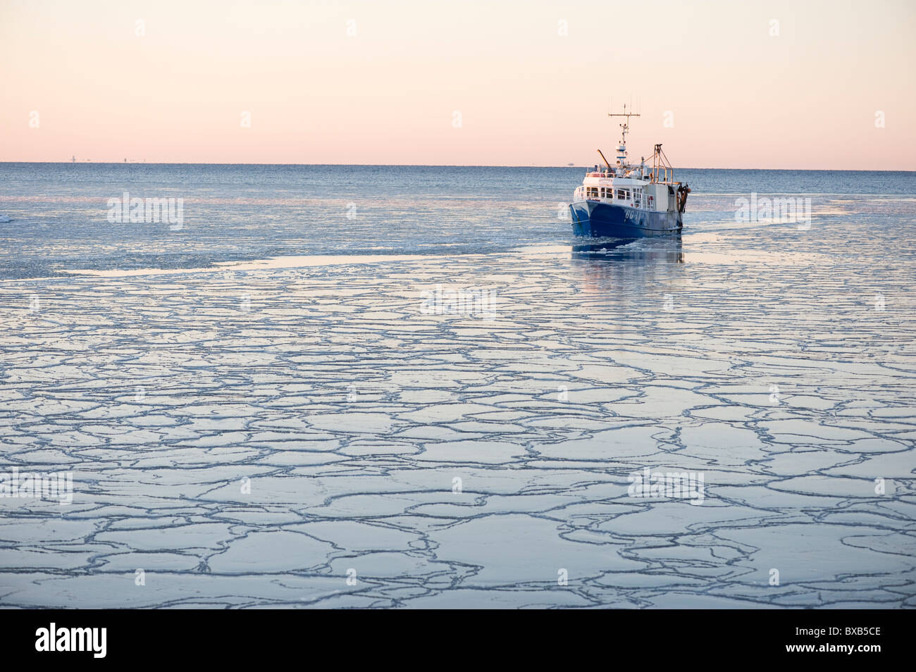 Trawler on frozen sea Stock Photo