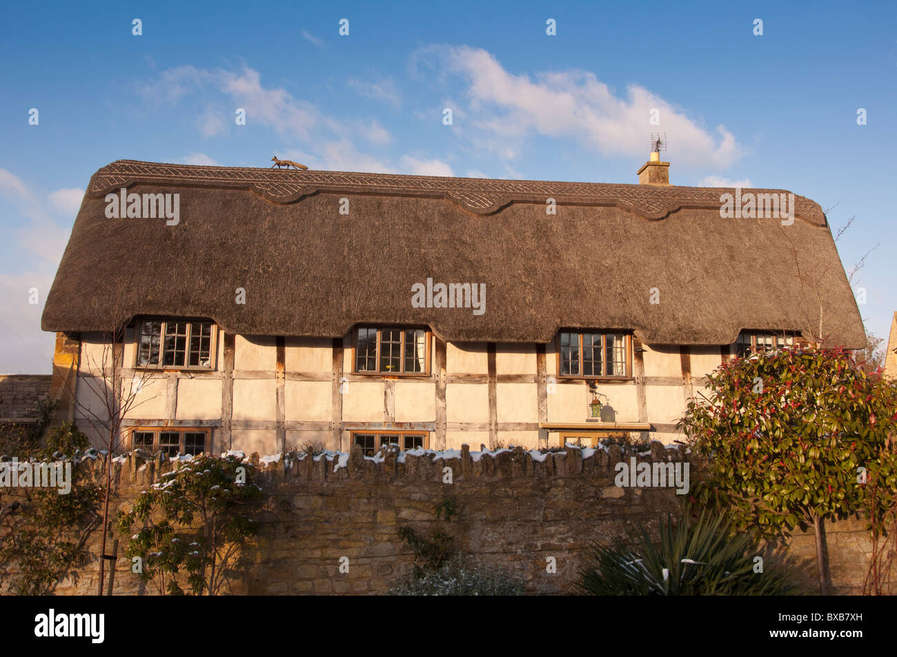 A converted thatched barn in the Cotswold village of Stanton, Gloucestershire, England Stock Photo