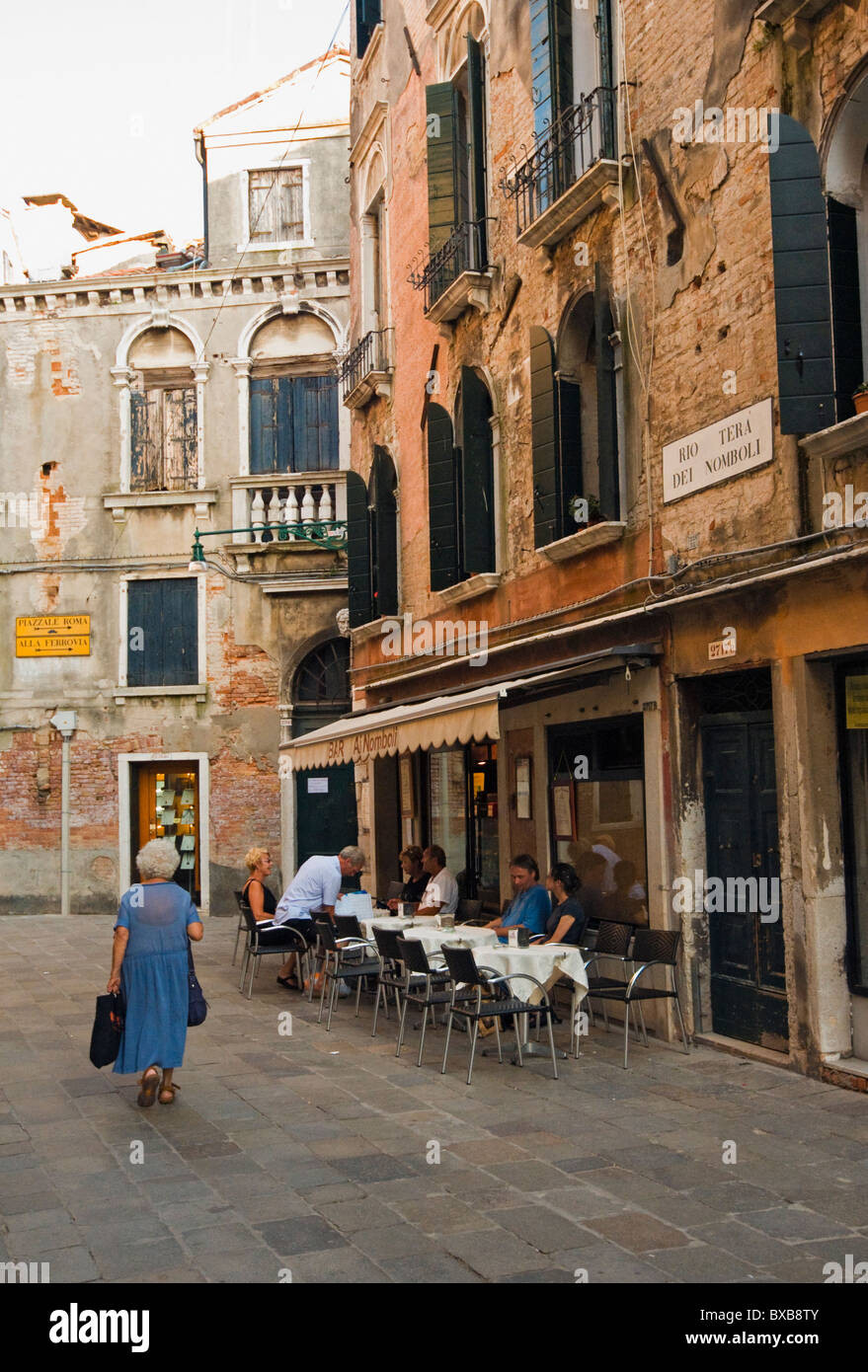 Street Scene with people Eating Out at Bar Ai Nomboli in San Polo District of Venice, Veneto, Italy Stock Photo