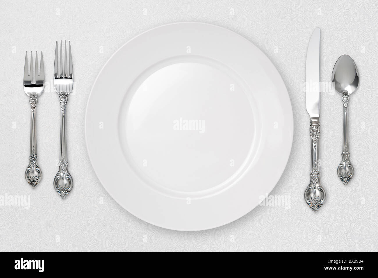 White Place Setting on tablecloth. Stock Photo