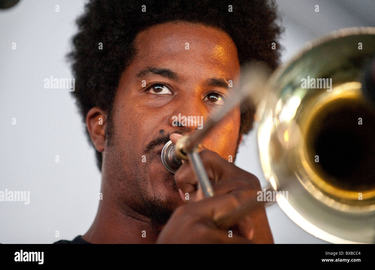 AfricanAmerican male guitarist trombone player in entertainment tent