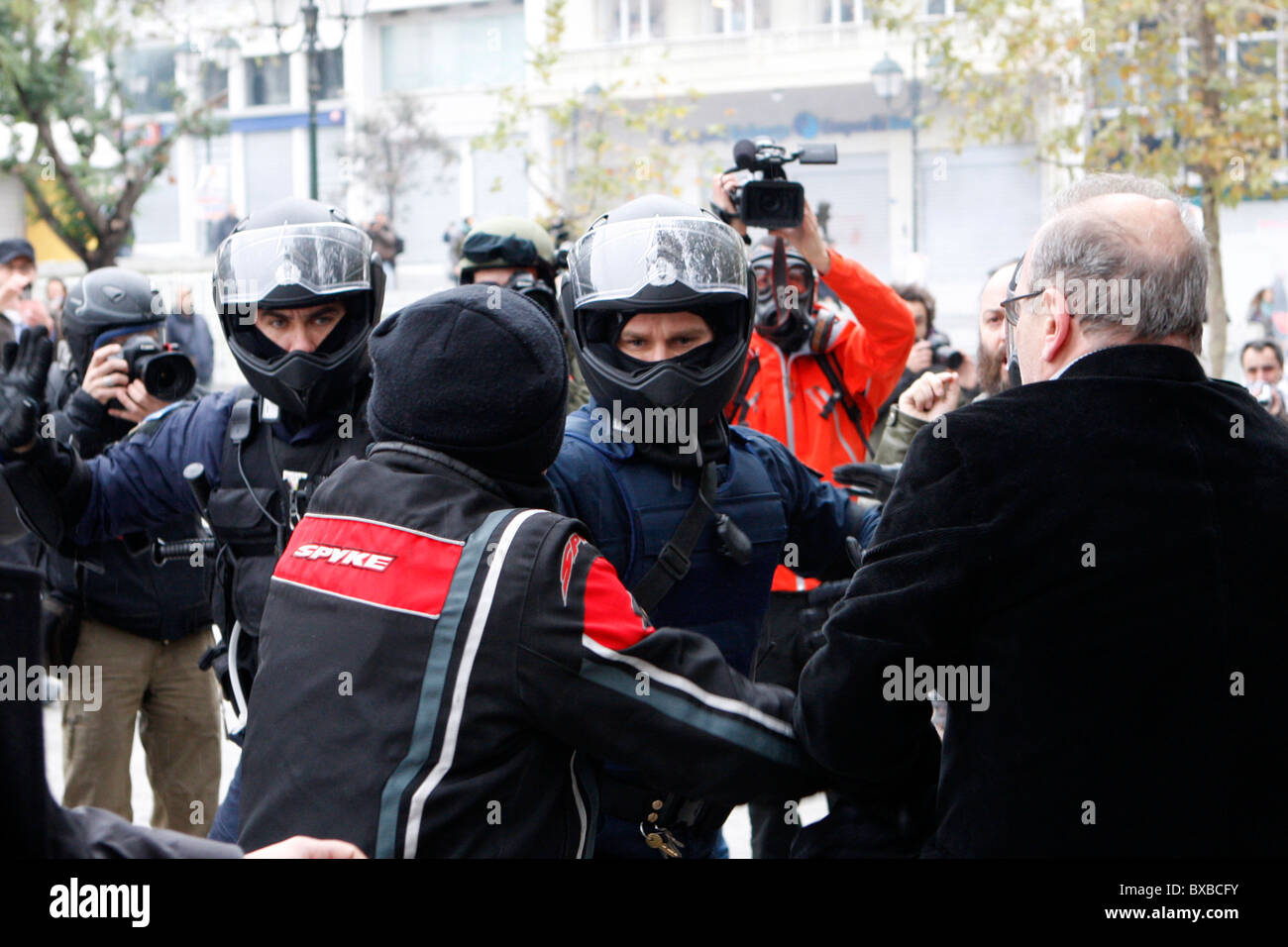 Protesters clash with the riot police, throw petrol bombs and stone against them. General strike in Greece as unions protest new labor reforms amid persisting austerity. Stock Photo