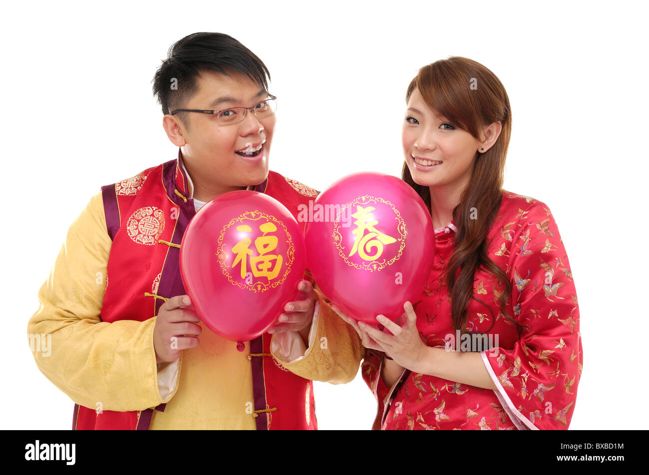 Couple holding balloons and smiling Stock Photo - Alamy