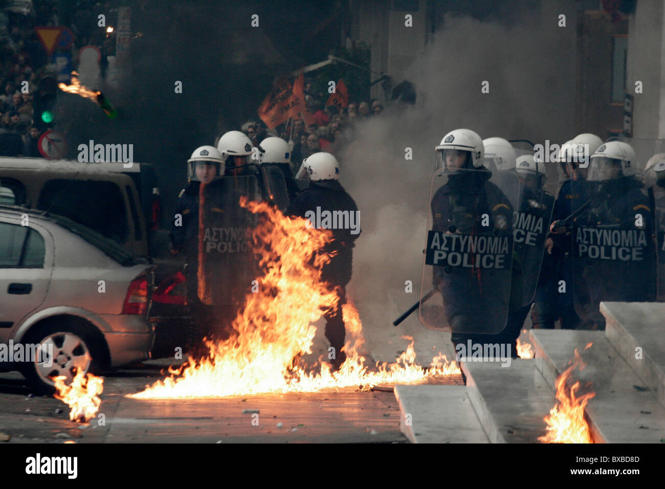 Protesters clash with the riot police, throw petrol bombs and stone against them. General strike in Greece as unions protest new labor reforms amid persisting austerity. Stock Photo