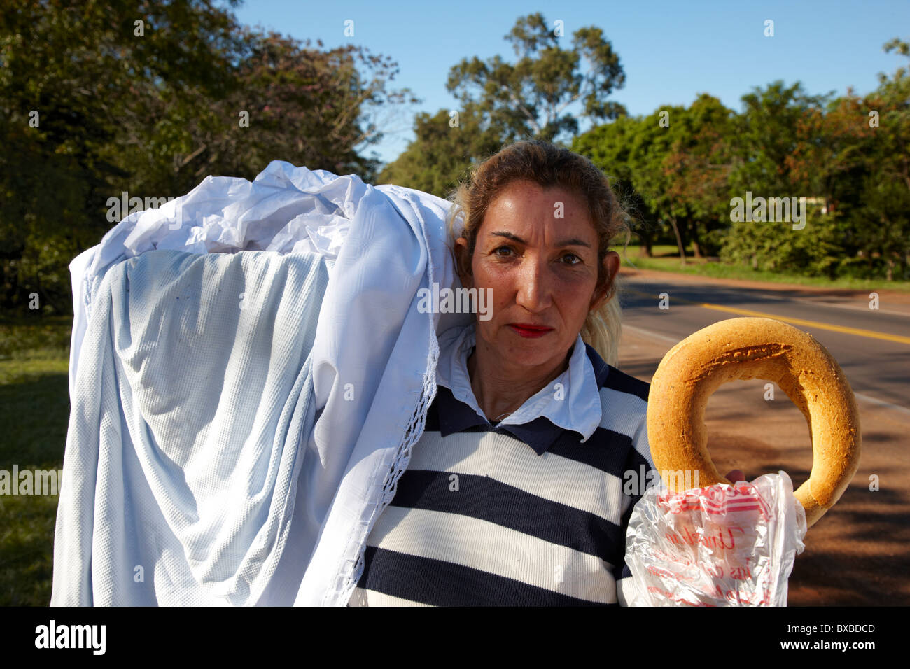 Paraguayan woman selling traditional chipa, Paraguay, South America Stock Photo