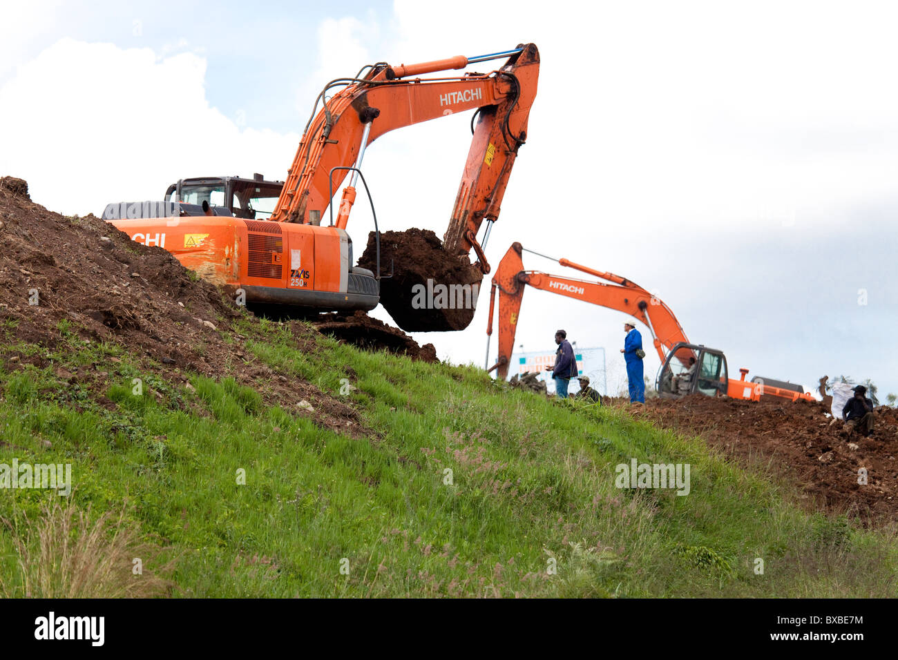 Excavator or digger heavy equipment working on highway construction in