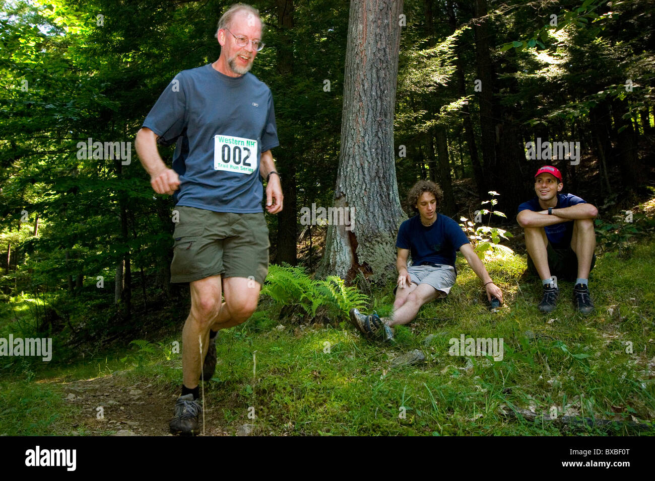 Trail runner runs through woods in a trail race competition with