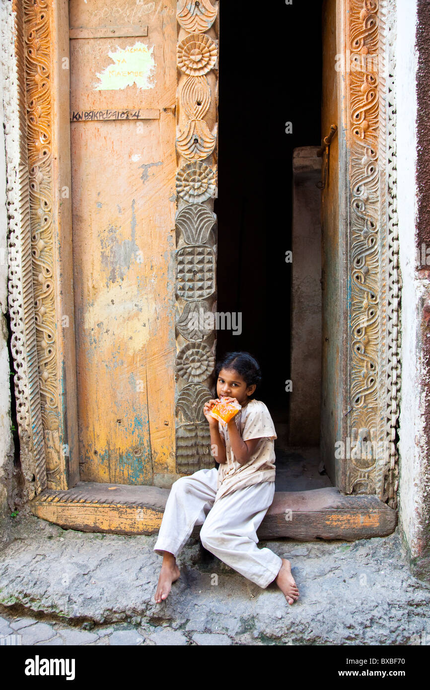 Little local girl in a doorway, Mombasa, Kenya Stock Photo