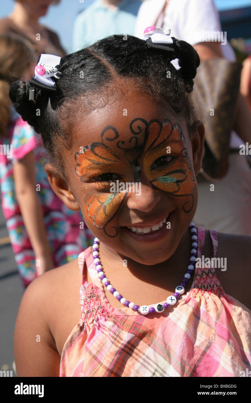 Young AfroAmerican girl with butterfly face paint. Beavercreek Popcorn
