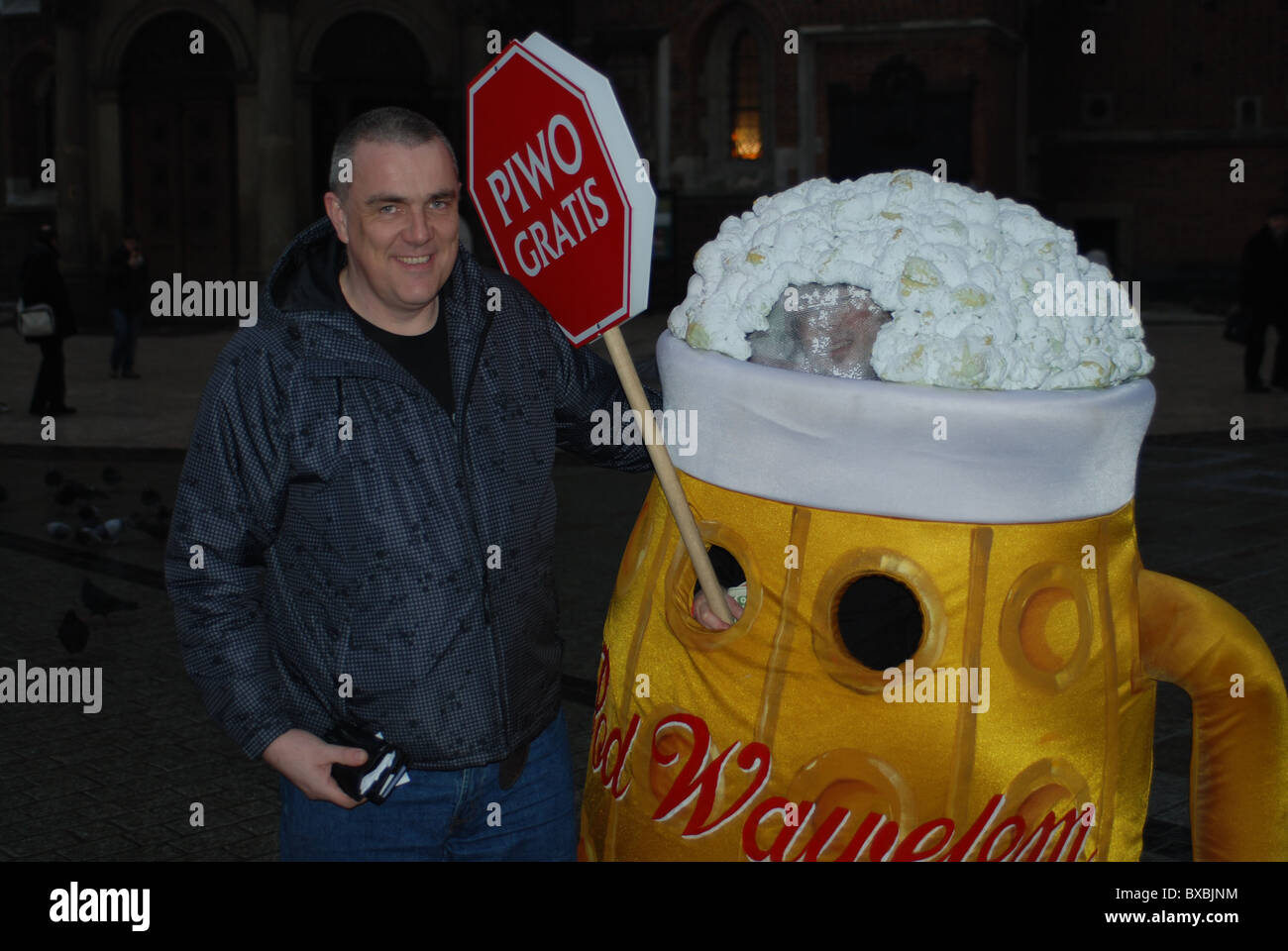 Man standing with a large beer sign, Piwo Stock Photo