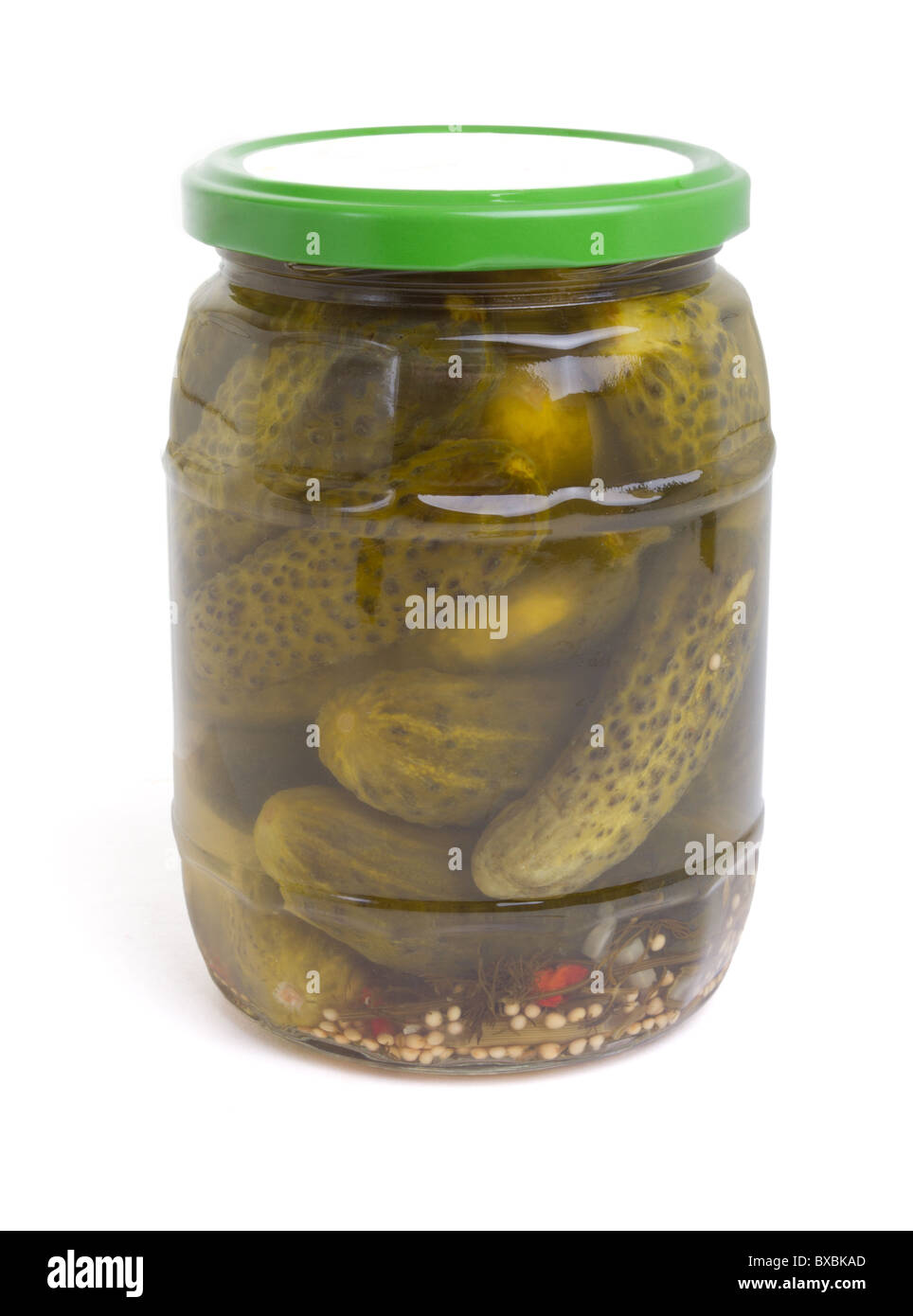Jar of Gherkins or dill pickle isolated on white. Stock Photo