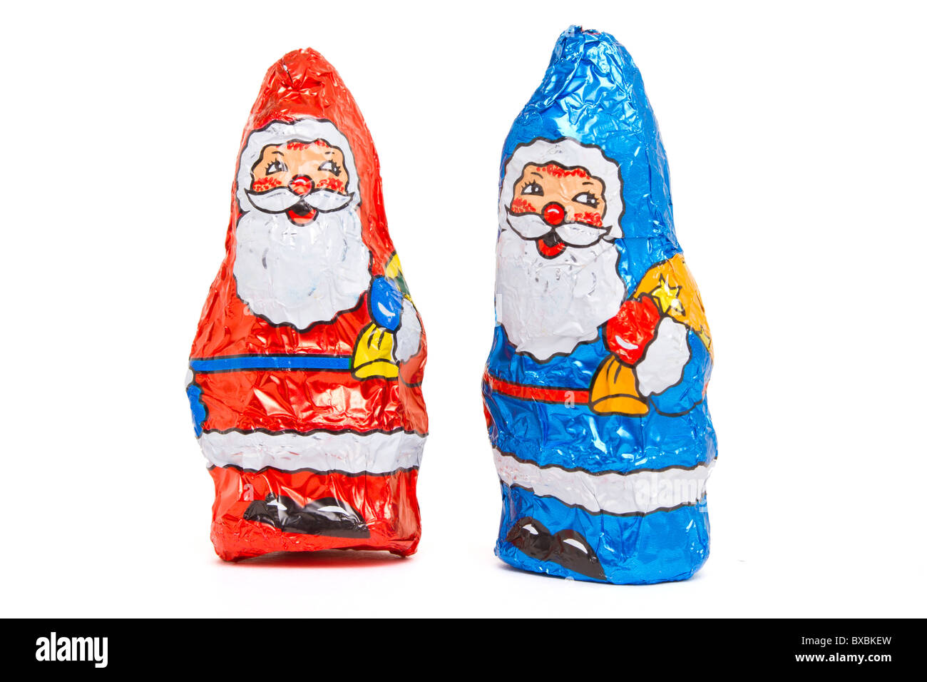 Red and Blue Foil wrapped Chocolate Santa isolated on white. Stock Photo