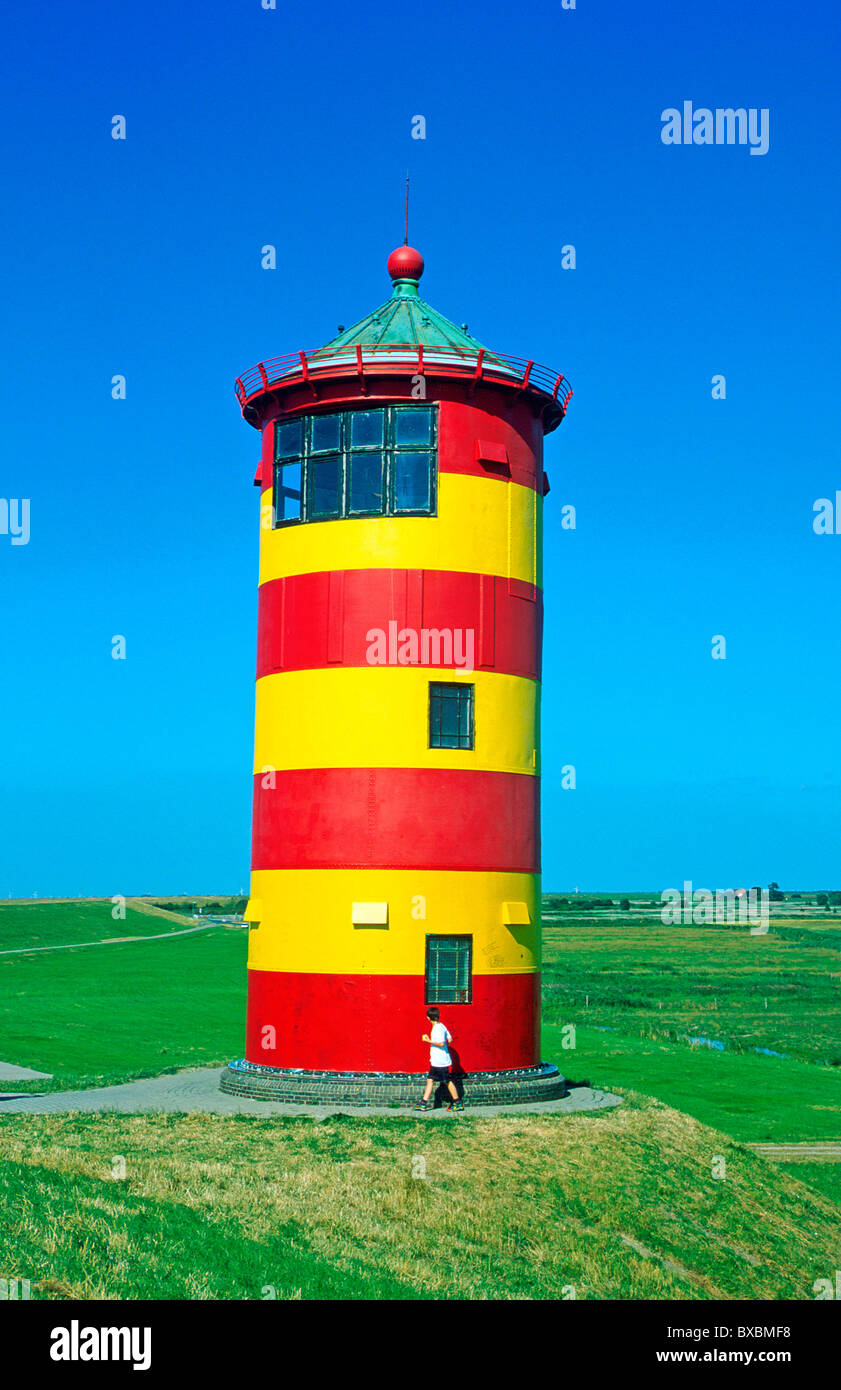 red and yellow lighthouse of Pilsum in East Friesland in Northern