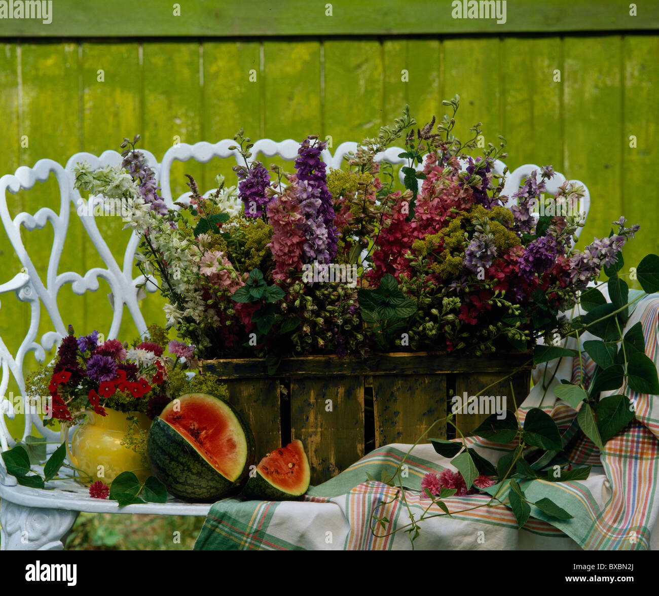 StillLife of pink, white and blue larkspur in rustic green basket on