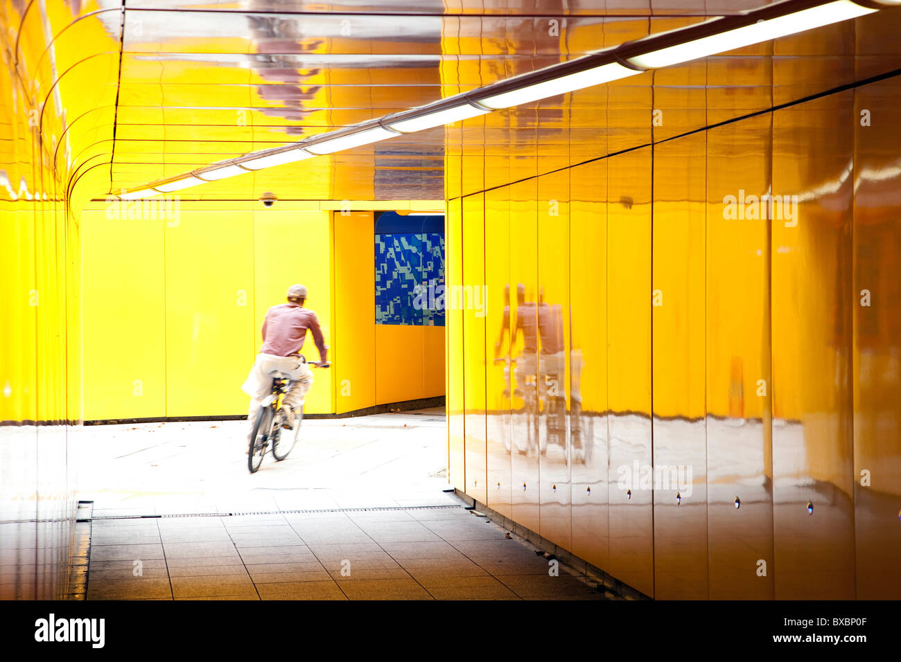 Cyclist riding through an underpass in London, England, United Kingdom, Europe Stock Photo