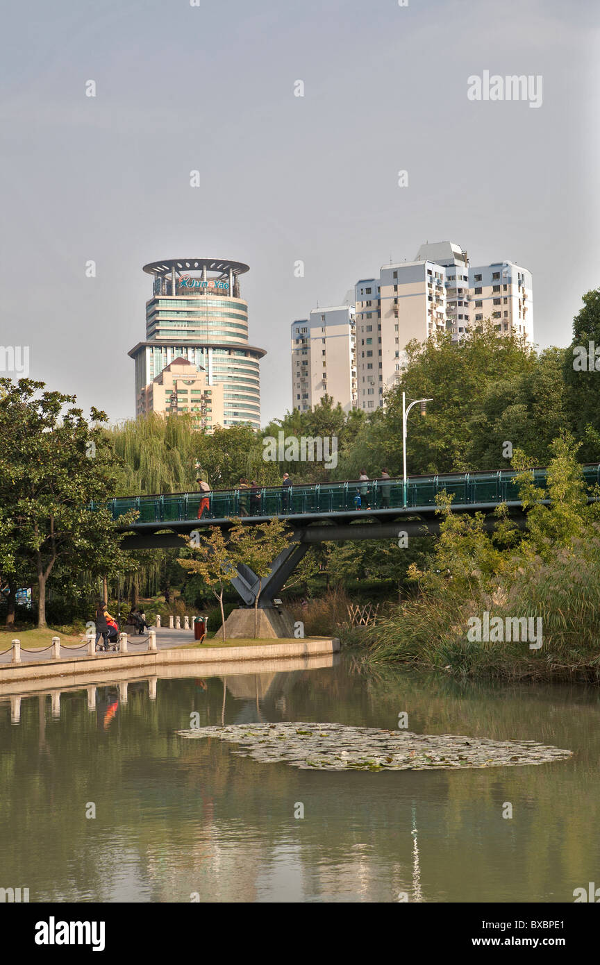 Lake with buildings in background, Xujiahui Park, Shanghai, China Stock Photo