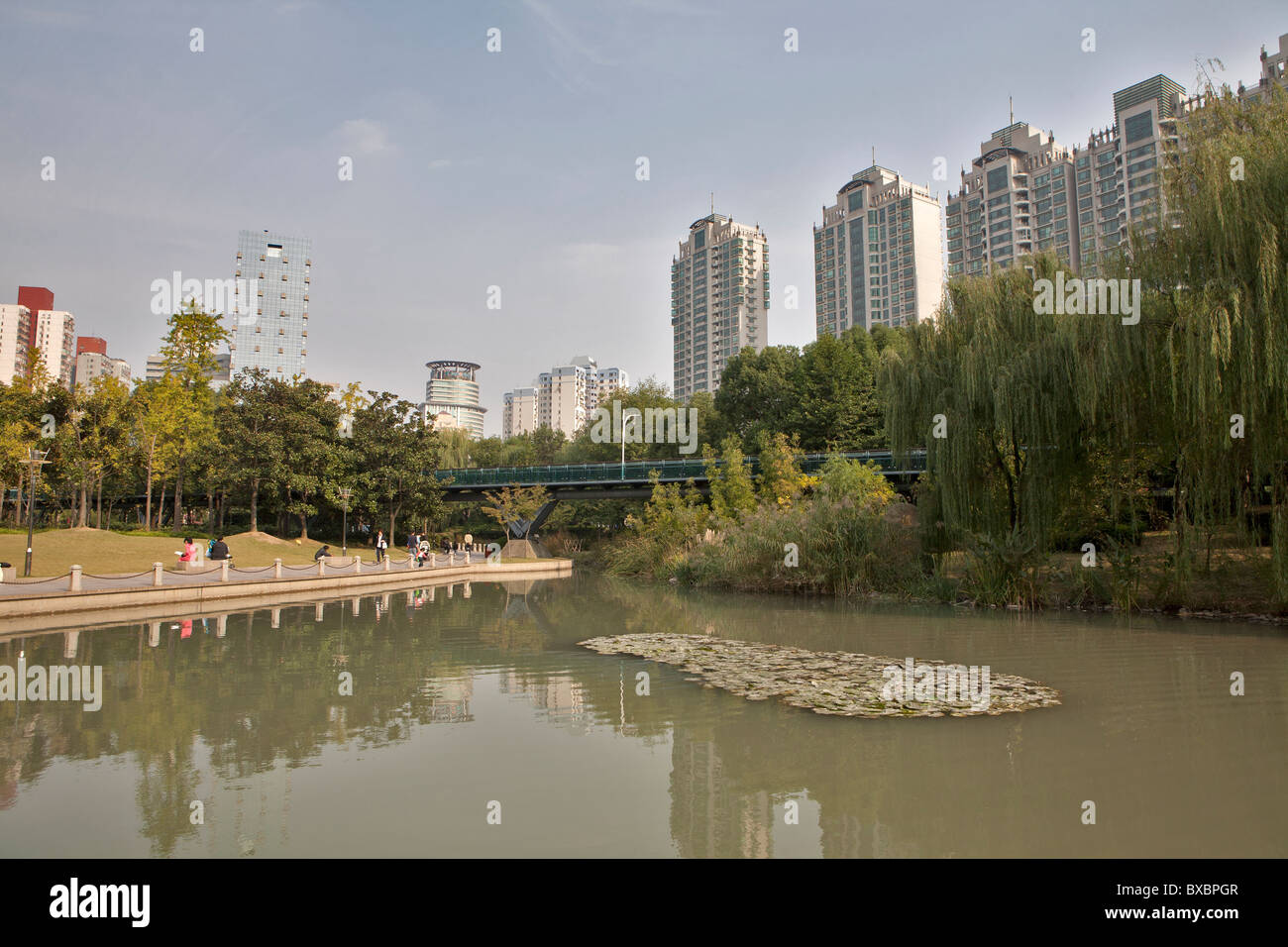 Lake with buildings in background, Xujiahui Park, Shanghai, China Stock Photo